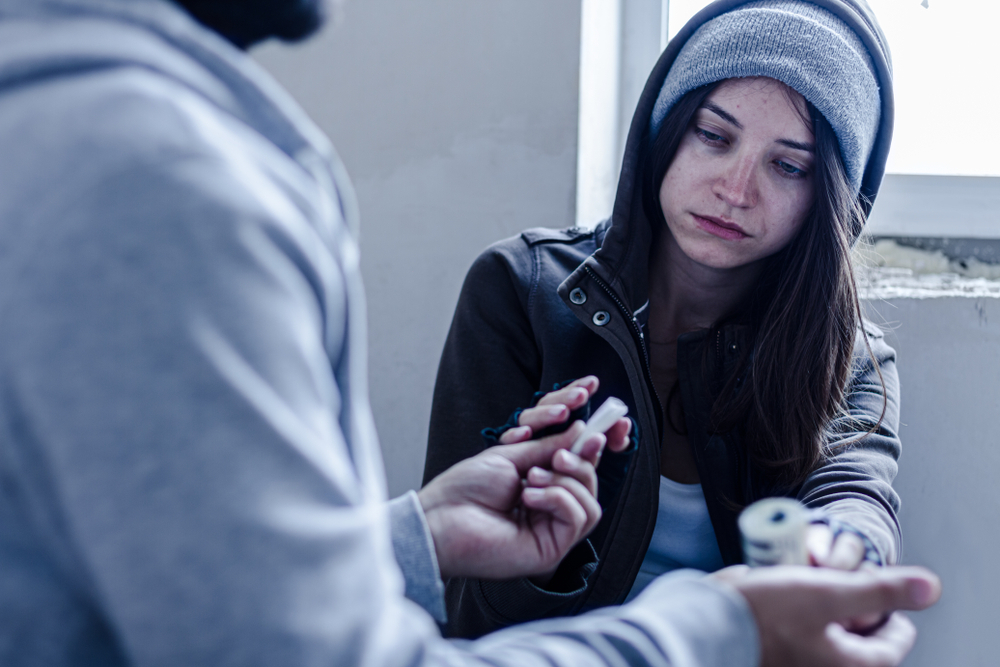 woman-taking-drugs-from-a-person