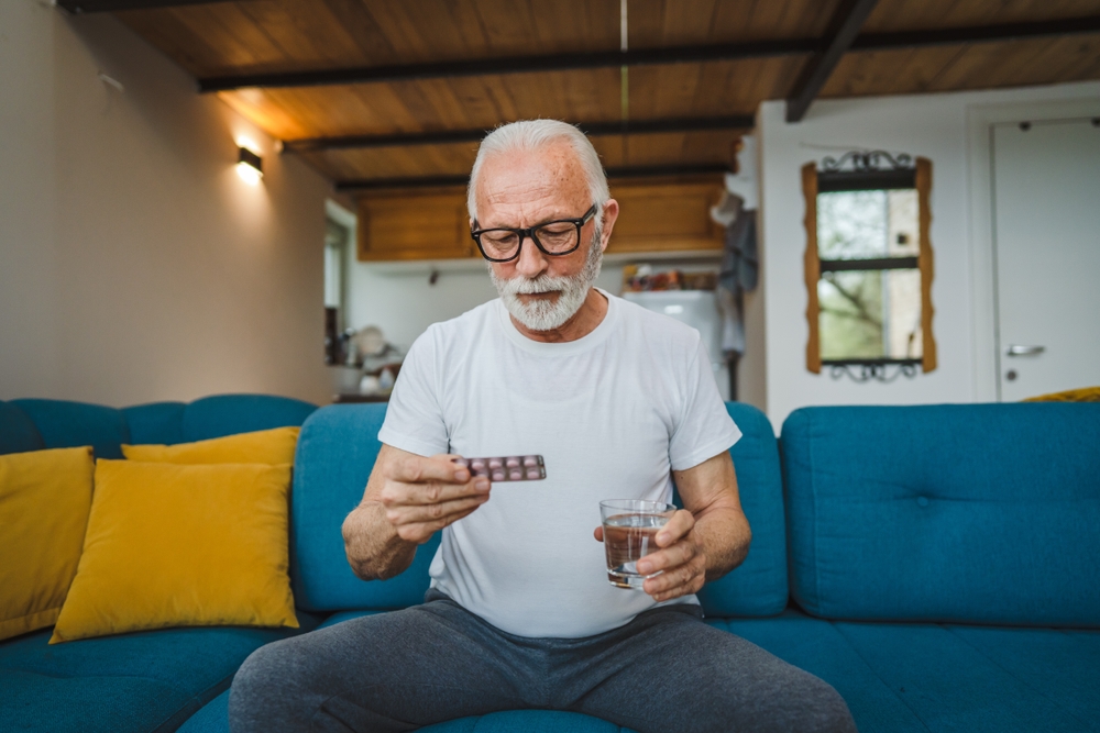 old-man-taking-pain-killer