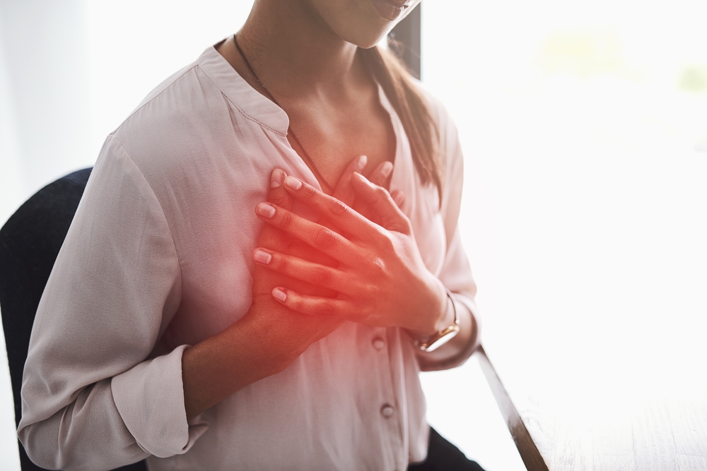 woman-feel-heart-pain-in-office