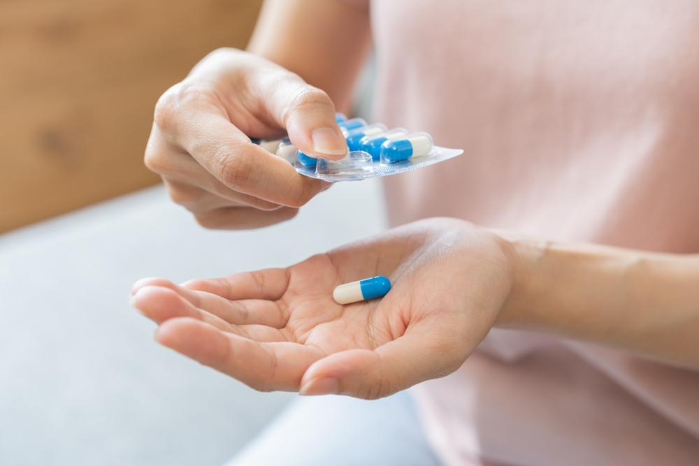 woman-taking-Disulfiram-tablet