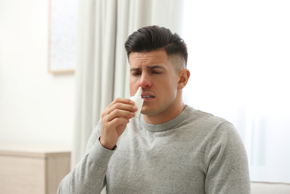man-using-nose-spray