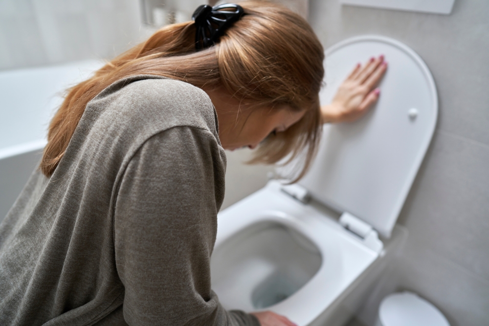 woman-bending-over-toitel-for-vomiting