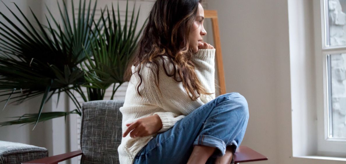 Depressed young girl sitting on chair