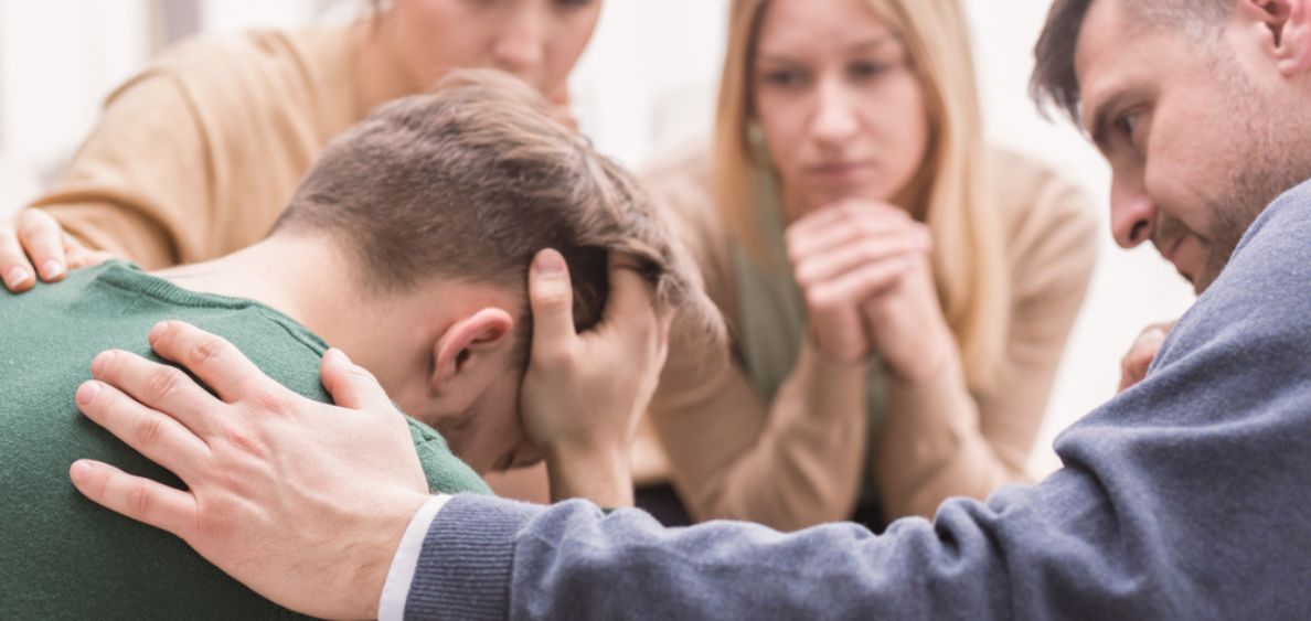 group of people supporting each other in rehab