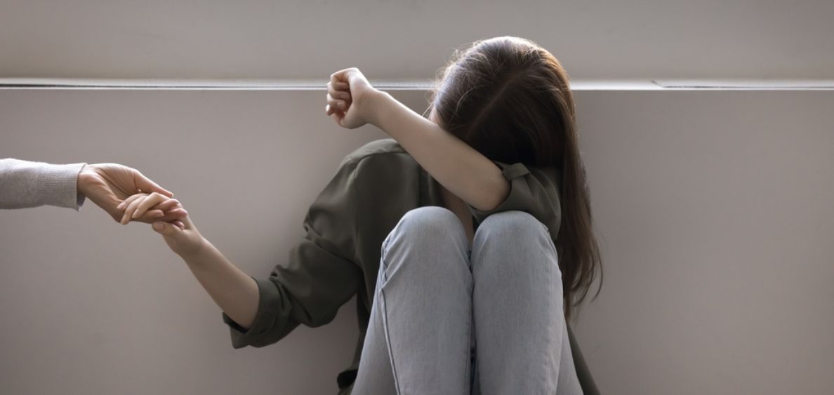 Young girl cryring because of addiction