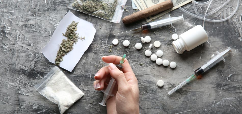 mans hand full of drugs