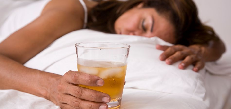 alcoholic woman sleeping on bed