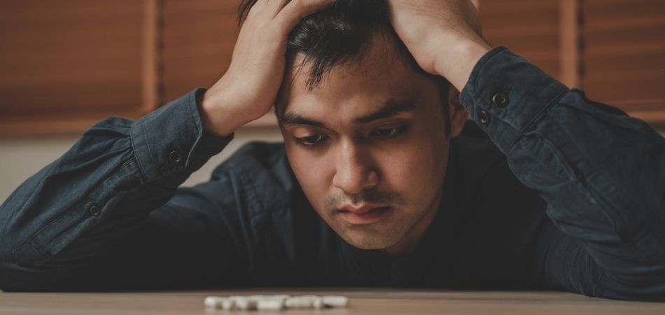 man suffering depression because of substance