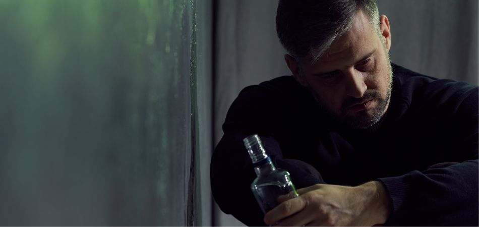 man with alcohol bottle in hand