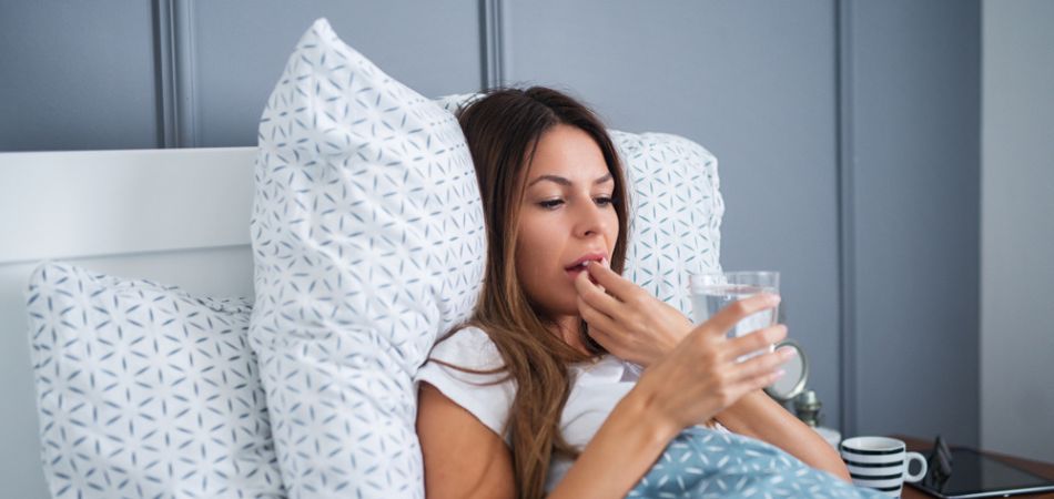 young-woman-taking-sleeping-pill