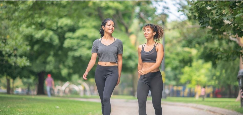 two young lady walking on the park