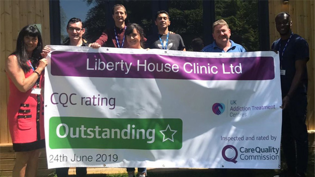 liberty house team holding cqc result banner