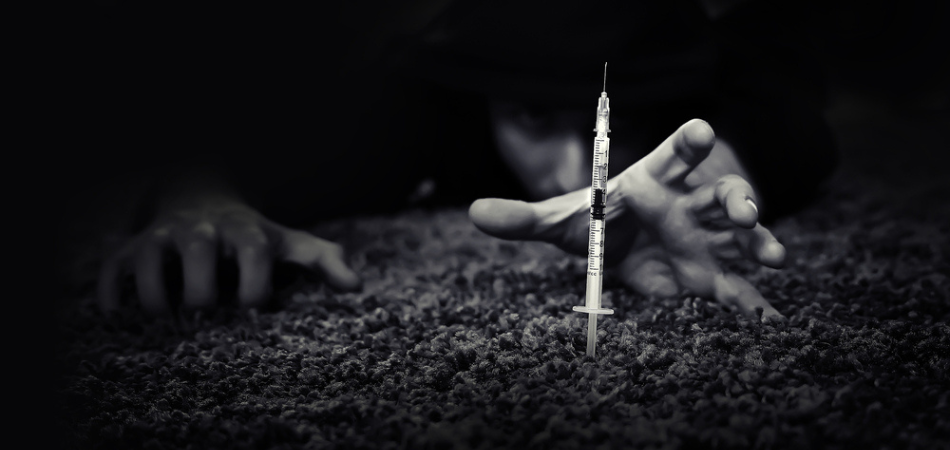 davina-mcalls-heroin-story-person-reaching-for-heroin-syringe