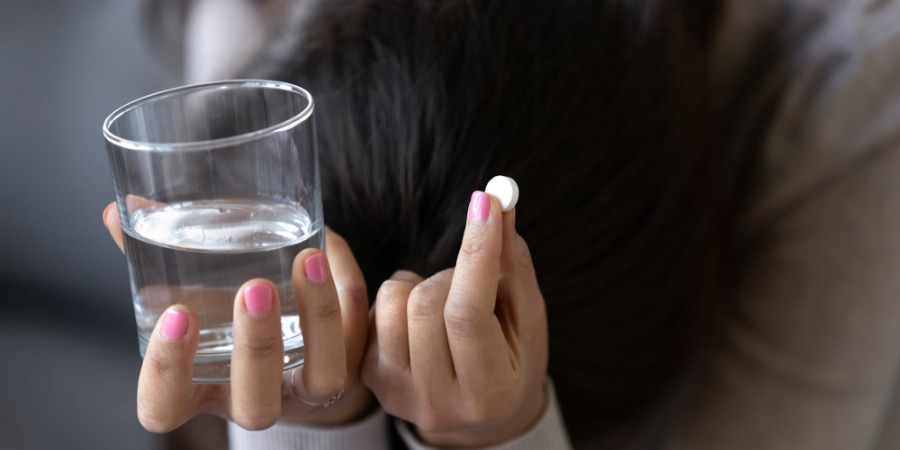 Depressed woman taking pill