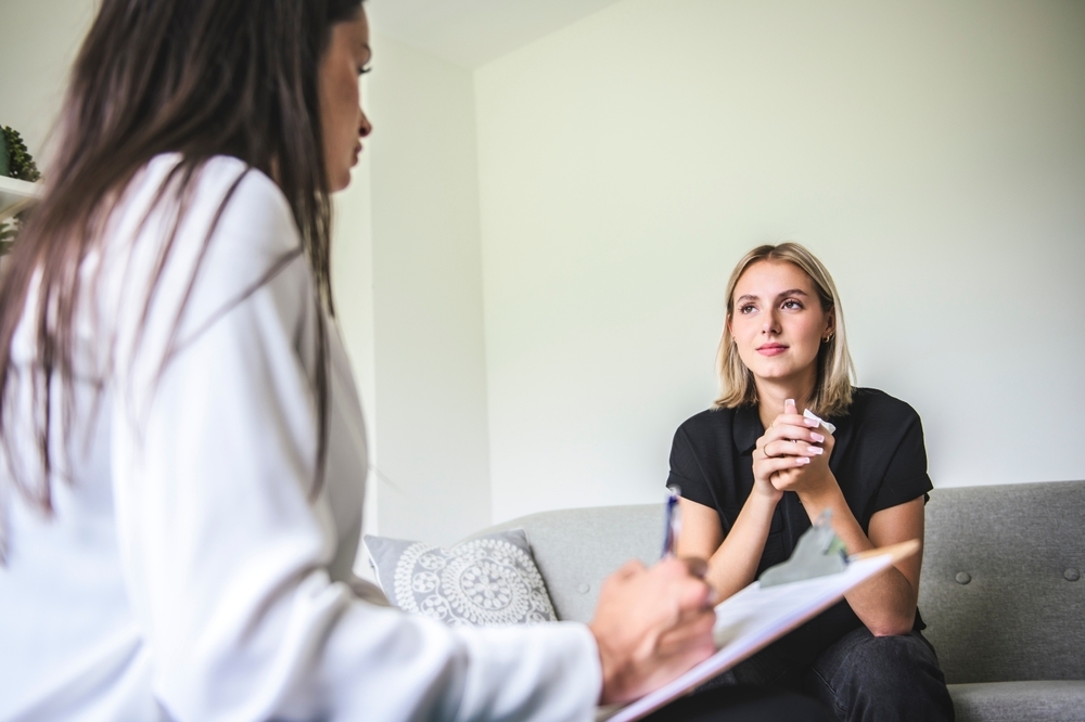 Psychotherapist supporting depressed teenage girl