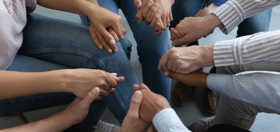 people holding hands in group therapy for zopiclone