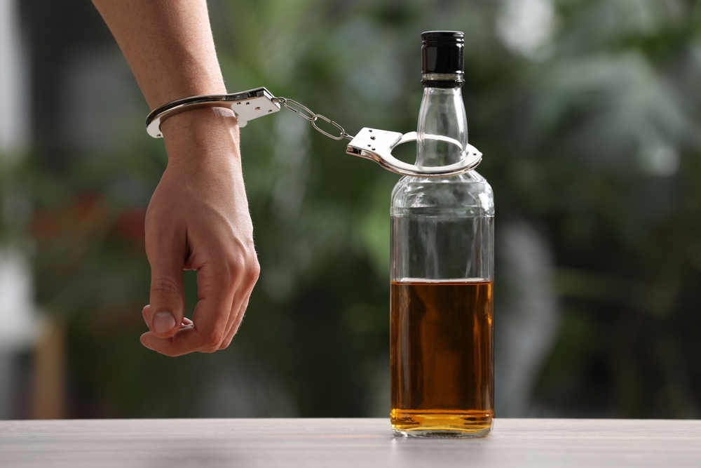 man hand with alcohol bottle