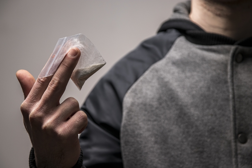 one pouch of heroin on man hand