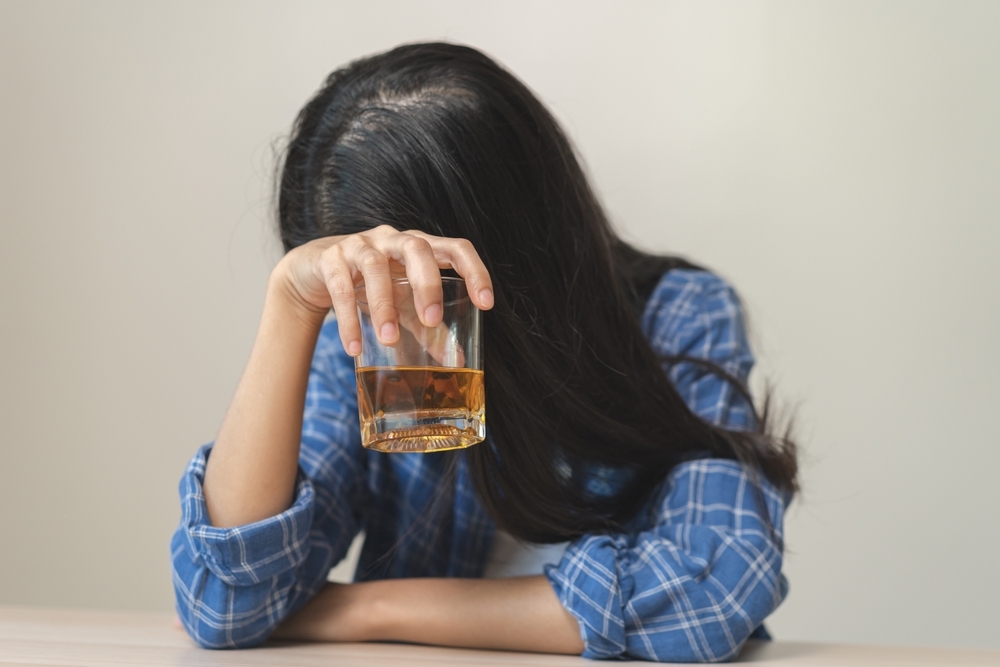 woman with alcohol in hand