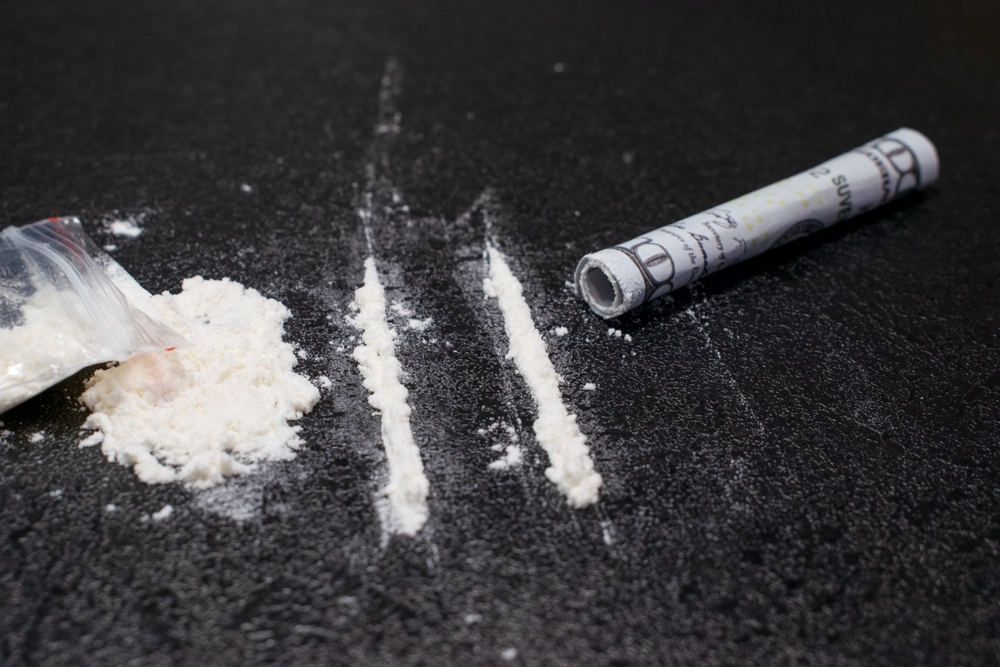 cocaine powder and roll on table