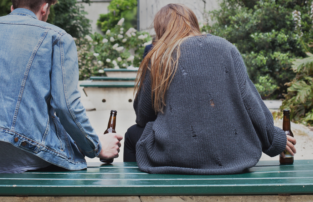 young-couple-drinking-at-park