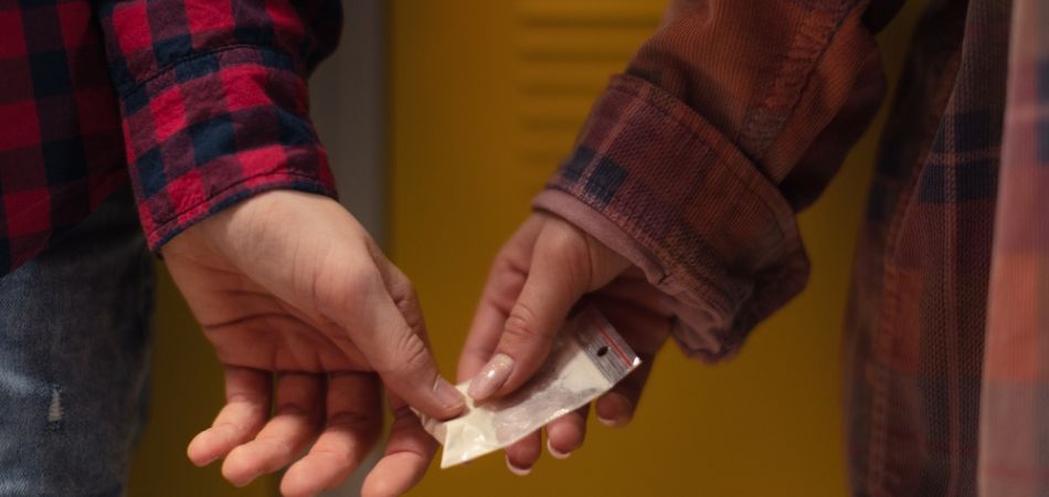 College boyes with cocaine in hand