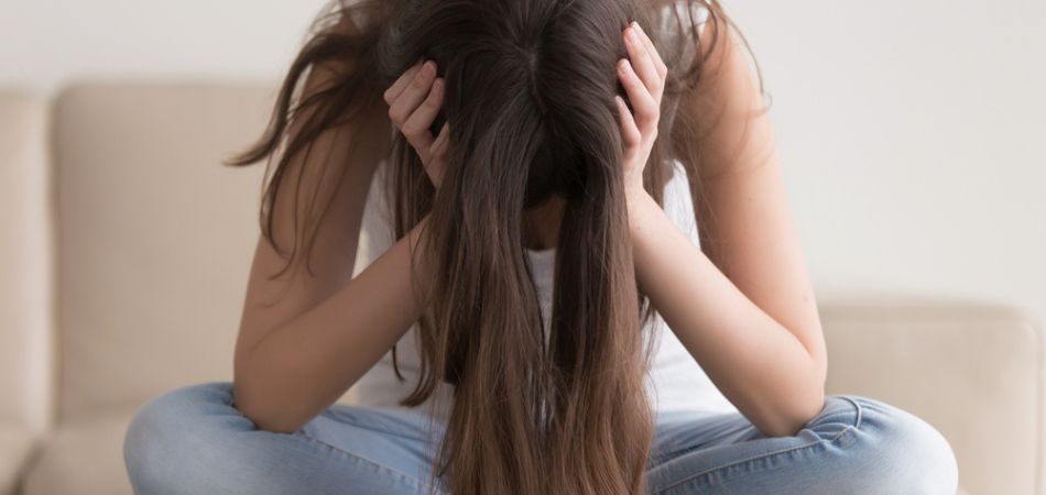 depressed-woman-sitting-on-sofa