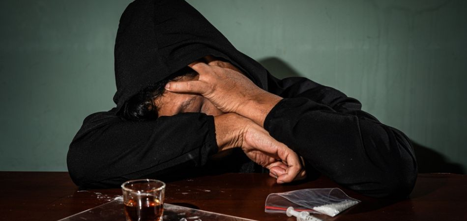 Man with drugs on the table