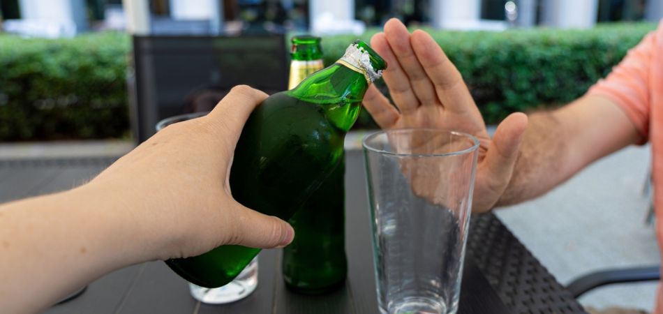 man hand says no to alcohol drinking