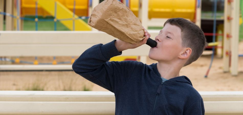 young child drinking alcohol
