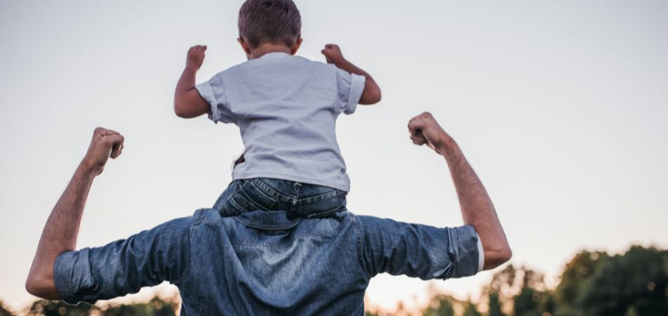 father supporting boy