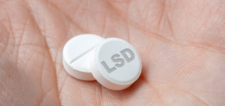 LSD addiction drugs in hand