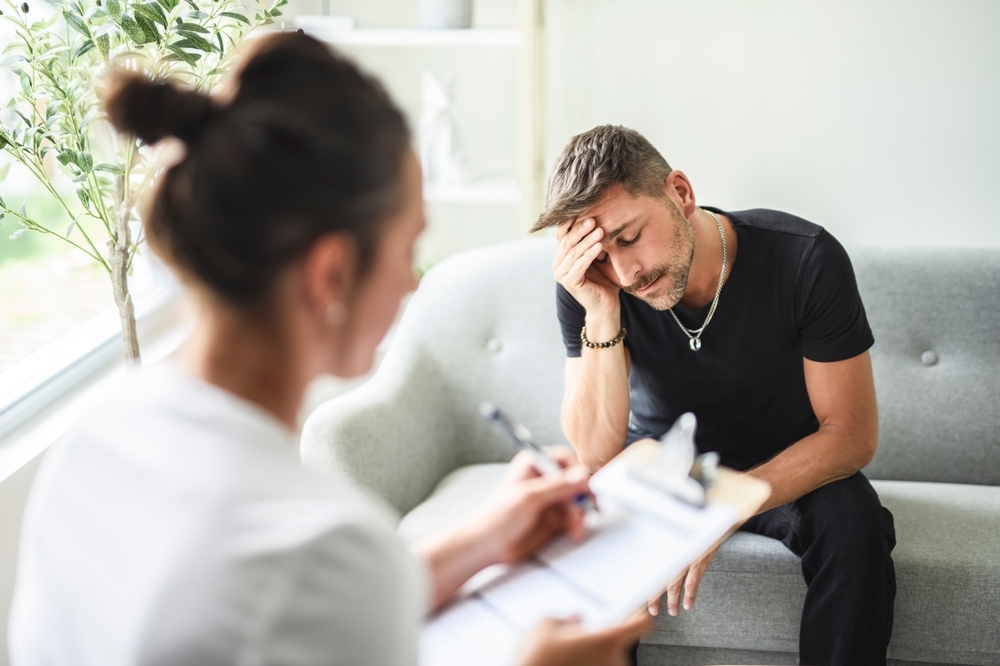 Man with doctor in rehab