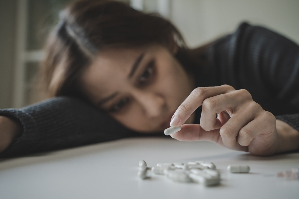 young woman with pills and tablets