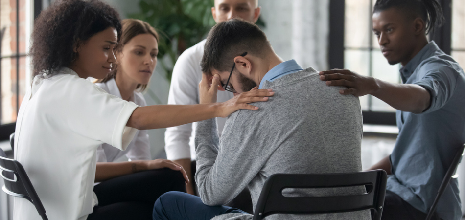 A man receiving support in group therapy for Drug rehab