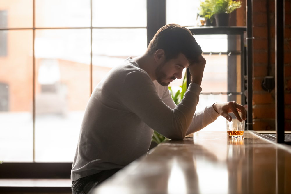 man in depression while drinking