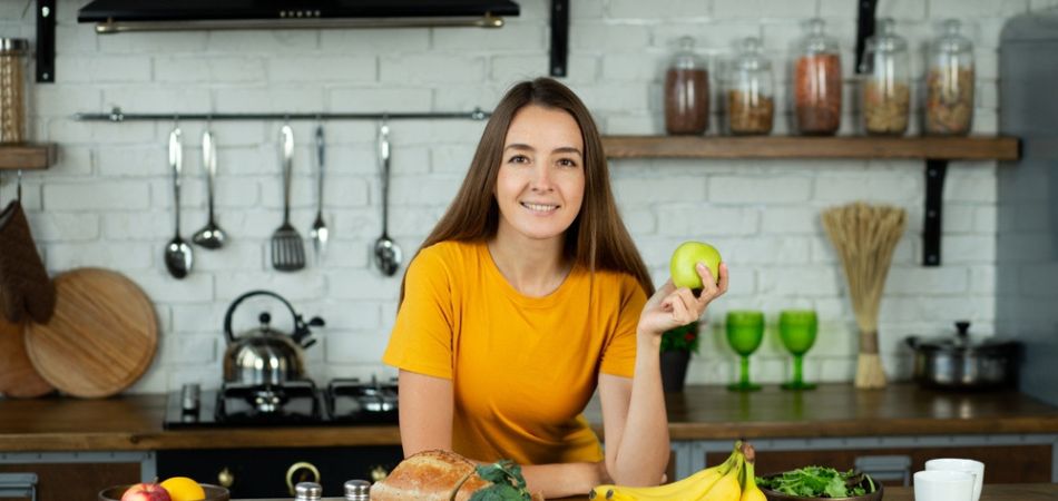 woman eating healthy food at home