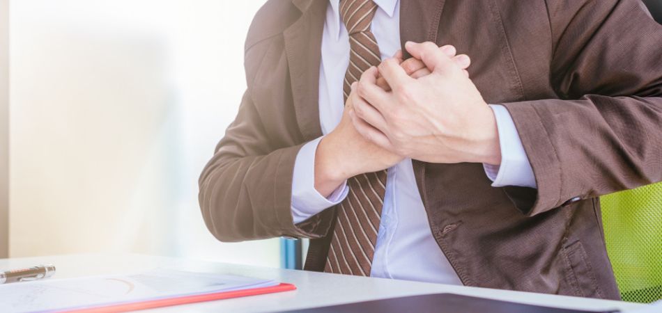 businessman feeling chest pain