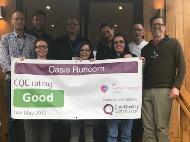 the oasis runcorn team holding cqc result banner