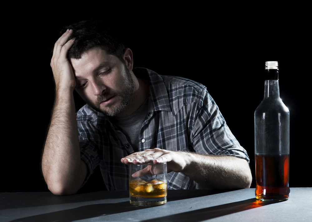 Man drinking alcohol alone