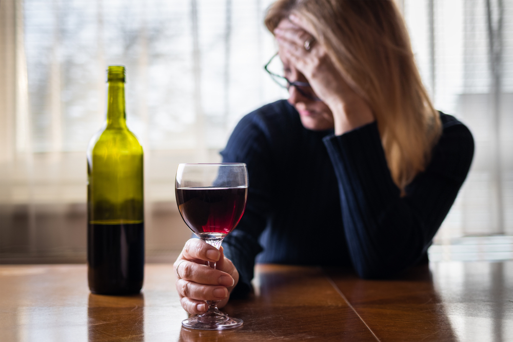 Woman driking alcohol alone