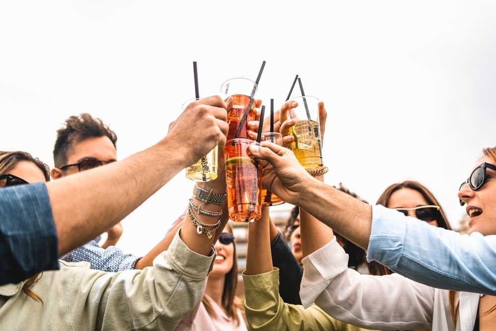 Group of people celebrate with beverage