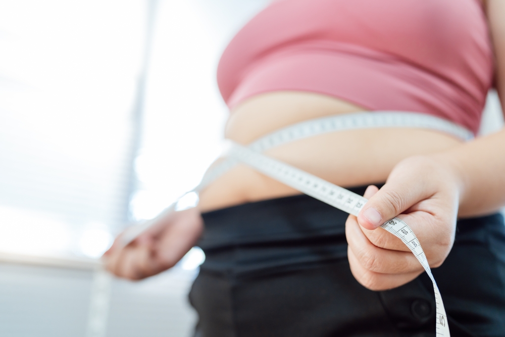 fat-woman-measuring-belly