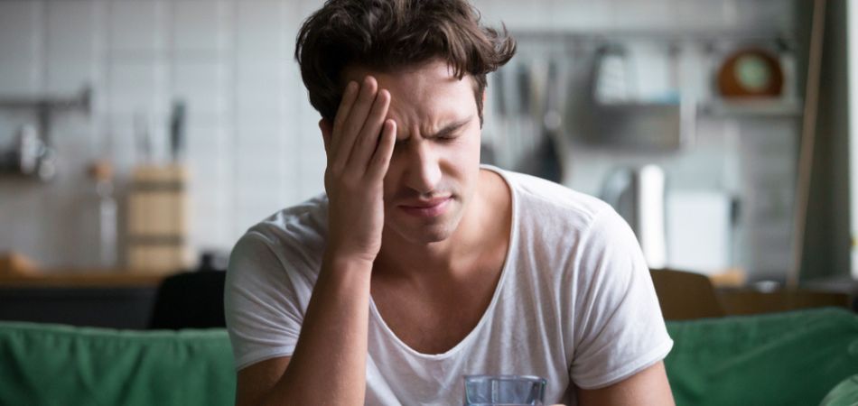 Young man suffring from alcohol addiction