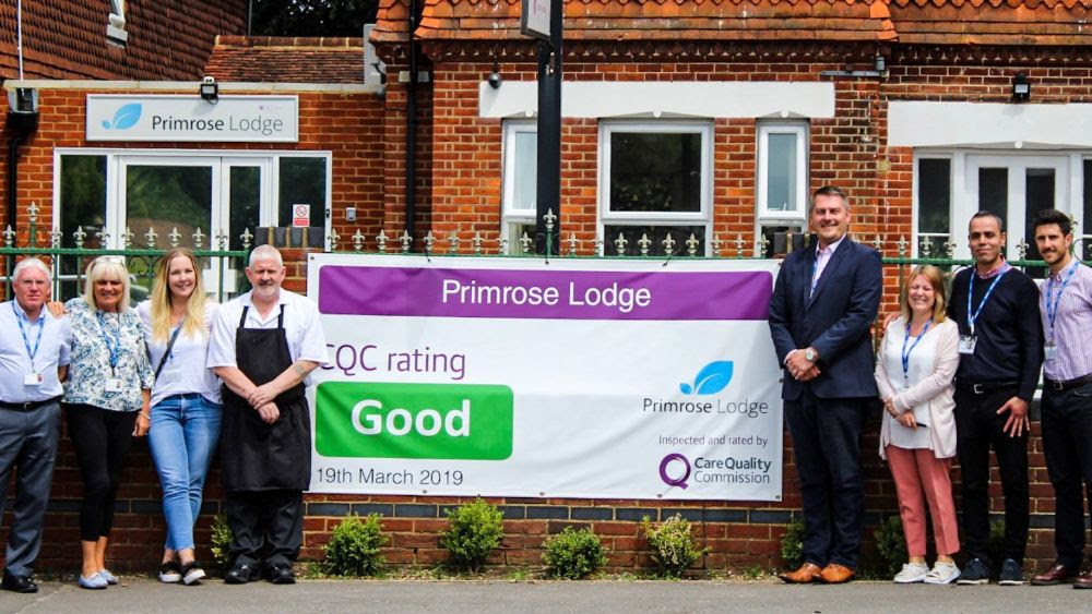 the primrose lodge team holding cqc result banner