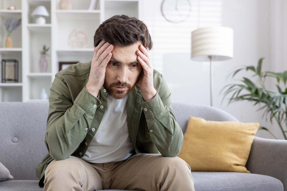 man-in-stress-sitting-on-sofa