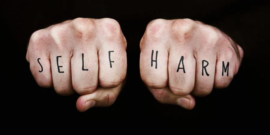 self-harm-and-addiction-self-harm-written-on-fists