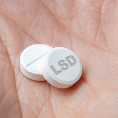 LSD pill on hand