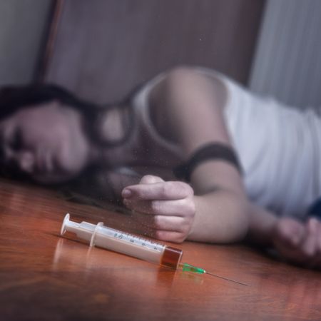 woman-lying-on-floor-after-taking-heroin