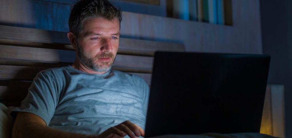 man watching porn at night